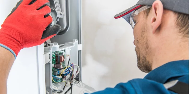 HVAC technician checking gas furnace