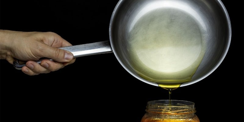 Pouring oil in mason jar